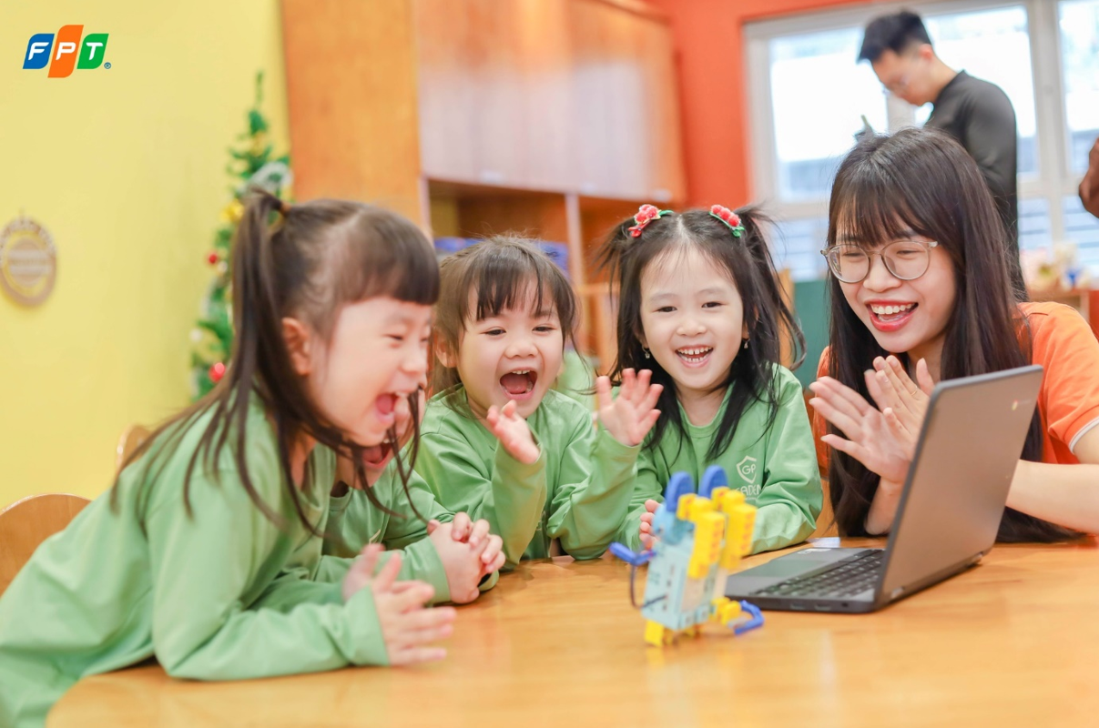 Các em nhỏ thích thú khi lần đầu tương tác và điều khiển robot giáo dục.